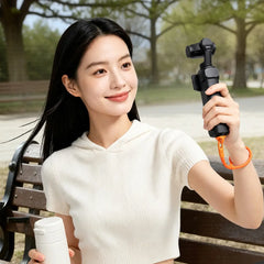 AeroFocus self-locking wrist strap attached to Insta360 Luna Ultra in a handheld shooting scene