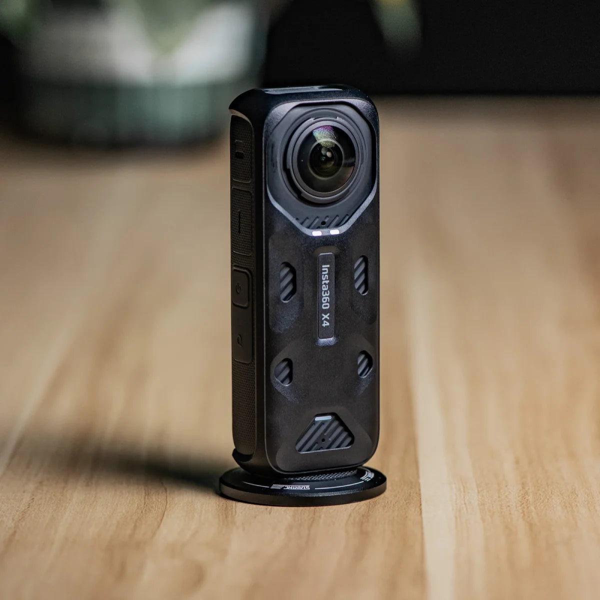 Insta360 X4 camera stabilized on a metal pole with the universal magnetic base.