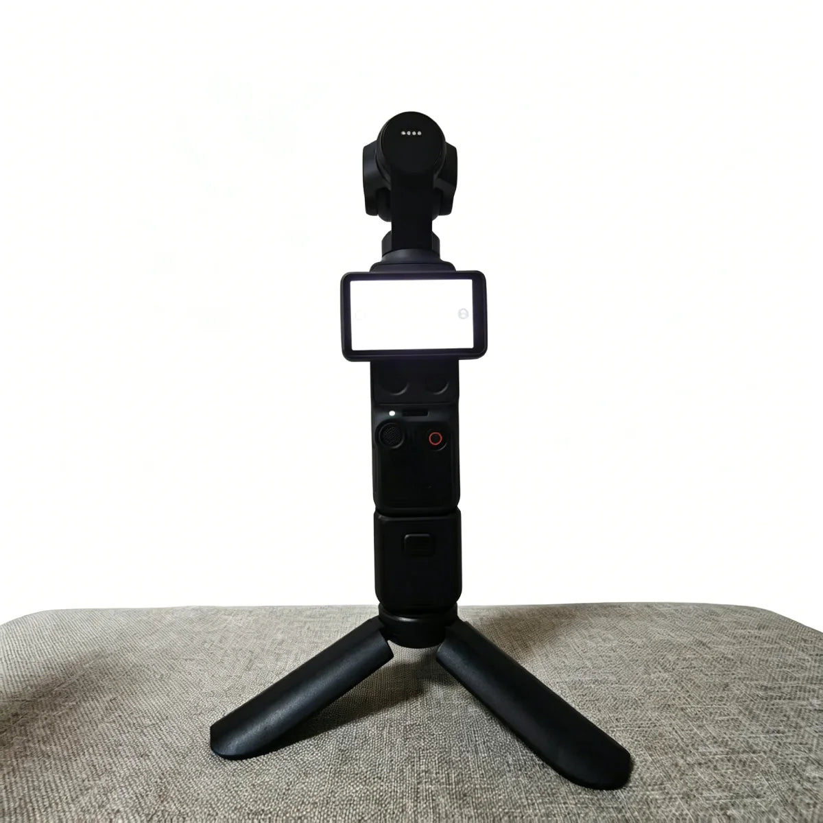 Mini tripod stand mounted on a DJI Osmo Pocket 4 camera.