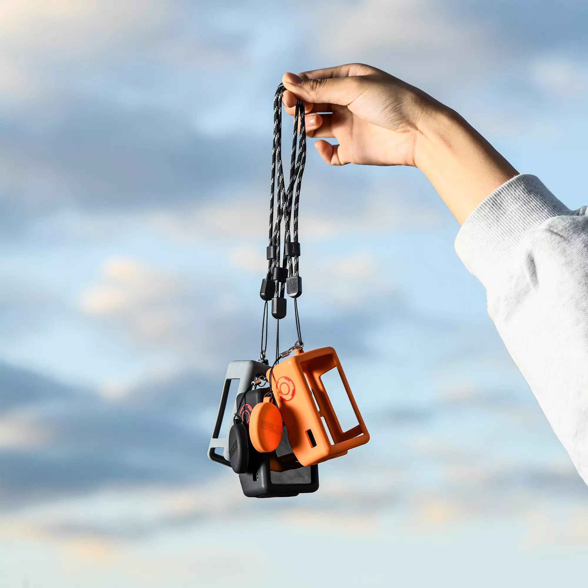 DJI Action 5 Pro case with portable hand strap for secure carry.