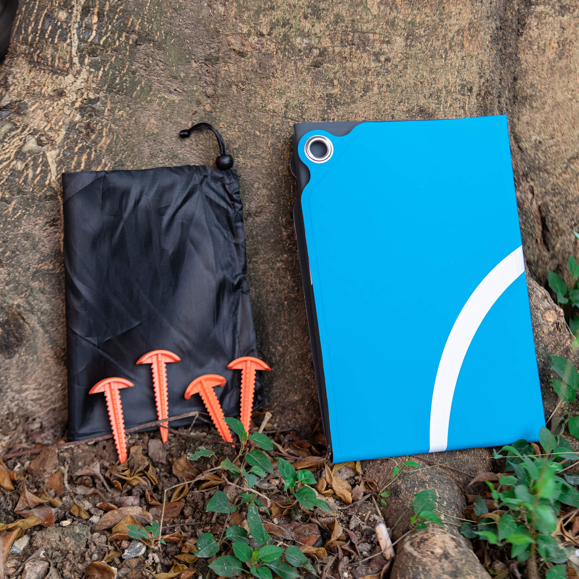 Drone landing pad with ground stakes for wind resistance and stability